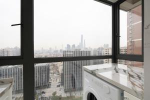 a laundry room with a view of a city at EHUB - Enjoy Shanghai Tower View with Floating Window, near Yuyuan Garden and the Bund in Shanghai