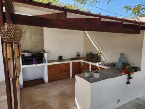 a kitchen with a sink and a counter top at Ponta Serenity Spot in Lopes