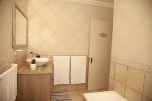 a bathroom with a sink and a toilet at Pine & Pebble in Centurion +12 photos