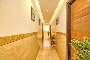 a corridor in a building with plants on the walls at Via Le Grand in New Delhi