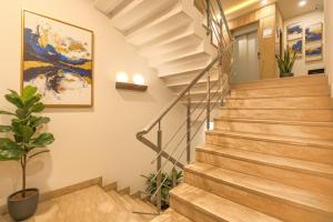 a staircase in a home with wooden stairs and a plant at Via Le Grand in New Delhi