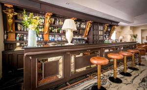 a bar at a hotel with stools in front of it at Grand Hotel Mediterranee in Alassio