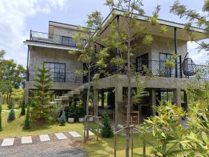 an exterior view of a house with a balcony at Honeymoon Moonlight Khaoyai in Ban Tha Wua Tai