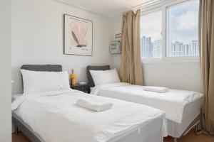 Ένα ή περισσότερα κρεβάτια σε δωμάτιο στο Panoramic View Seoul Station 2BR Newly Built