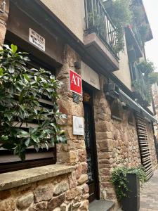 a sign on the side of a brick building with a door at Apartamentos Ubaga in Ezcaray