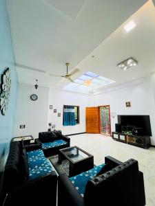a living room with couches and a flat screen tv at GA Bunglow 4Bhk Villa with pool in Lonavala