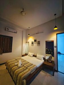 a bedroom with a bed with a teddy bear on it at GA Bunglow 4Bhk Villa with pool in Lonavala