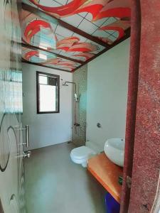a bathroom with a toilet and a sink at GA Bunglow 4Bhk Villa with pool in Lonavala +6 photos