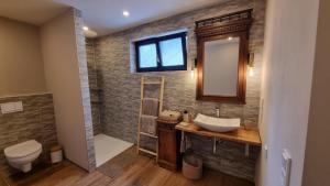 a bathroom with a sink and a toilet and a mirror at Ferienwohnung Wie dehemm in Sankt Ingbert +16 photos