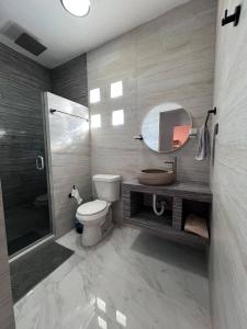 a bathroom with a toilet and a mirror and a shower at Serene Retreat in Guaymas, Mexico - Your Home Away from Home in Colonia Miramar