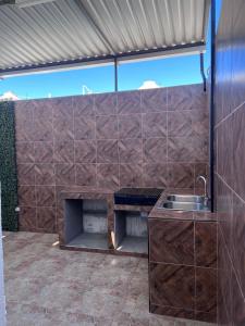 an outdoor kitchen with a counter and a sink at Serene Retreat in Guaymas, Mexico - Your Home Away from Home in Colonia Miramar +8 photos
