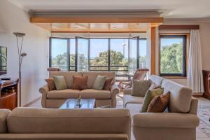 a living room with two couches and a table at Vista Atlântica-Vila do Conde in Vila do Conde