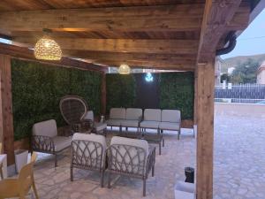 a group of chairs sitting under a pavilion at Villa Perla Del Mare in Mondragone