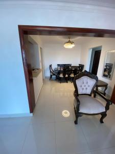 a living room with a chair and a table at Comfort Apt Urbanization Italia in front of the park in Ensanche Savica de Mendoza