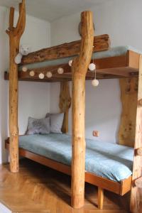 two bunk beds in a room with wooden floors at Chata na Bunči in Roštín