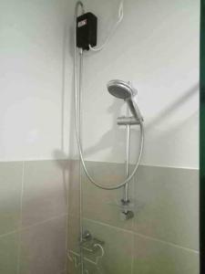 a shower in a bathroom with a shower head at The Loop Tower Downtown City Centre Comfy 2bR in Pontud
