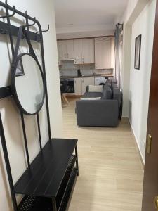 a living room with a mirror and a couch at Apartamento Boston in Zaragoza