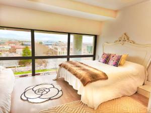 a bedroom with a bed and a large window at Madrids sky Luxury Penthouse 6Pax 10 min Airport in San Sebastián de los Reyes