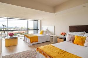 a bedroom with two beds and a large window at Dúplex Icónico y Exclusivo en Madrid 6pax AirPort in San Sebastián de los Reyes +40 photos