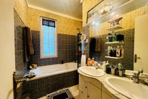 a bathroom with a tub and a sink and a bath tub at 16th 10 minutes from the Eiffel Tower Metro line 9 in Paris
