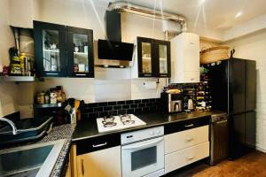 a kitchen with a sink and a stove top oven at 16th 10 minutes from the Eiffel Tower Metro line 9 in Paris