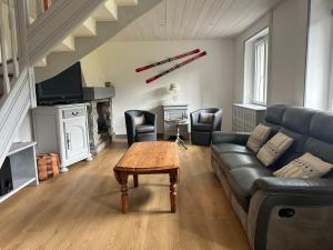 a living room with a couch and a table at Le Cabanon de L'Arbey in Pierrefitte-Nestalas
