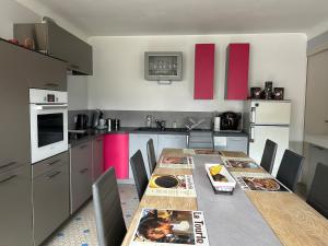 a kitchen with a long table with chairs in it at Le Cabanon de L'Arbey in Pierrefitte-Nestalas