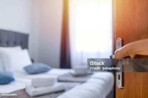 a person is opening a door to a bed at The Granary Apartments in Copenhagen