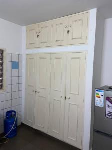 a group of white cabinets in a kitchen at villaTokoin in Lomé