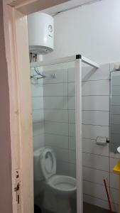 a bathroom with a white toilet in a stall at villaTokoin in Lomé +5 photos