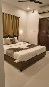 アーポラにあるHotel Coco Goaの木製のフレームの大きなベッドのある寝室