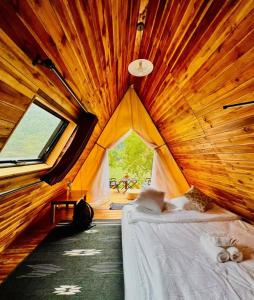 a bedroom with a bed in a wooden room at Papaya Resort Nong Khiaw in Nongkhiaw