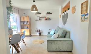 a living room with a couch and a table at Urban loft Valencia playa in Puebla de Farnals