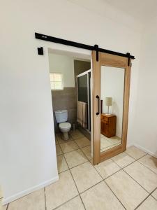 an open door to a bathroom with a toilet at Good Hope Farm in Sunland +19 photos