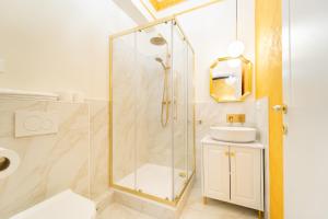 a bathroom with a glass shower and a sink at Iconic Rooms Verona in Verona +32 photos