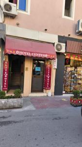 a store with a red awning on a building at Center Elite in Tirana +49 photos
