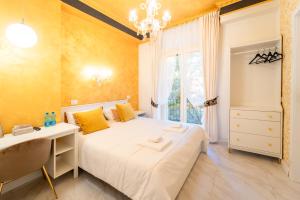 a bedroom with a bed and a desk and a window at Iconic Rooms Verona in Verona