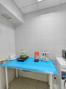 a room with a blue table in a kitchen at apartments with shared bathroom in Cherkasy