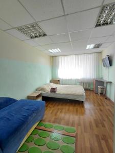 a bedroom with two beds and a rug on the floor at apartments with shared bathroom in Cherkasy