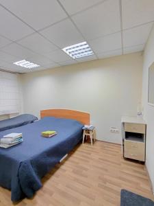 a bedroom with a bed and a table in a room at apartments with shared bathroom in Cherkasy +3 photos