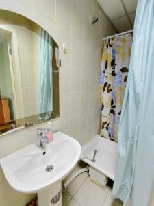 a bathroom with a sink and a shower curtain at apartments with shared bathroom in Cherkasy