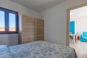 a bedroom with a bed and a view of the ocean at La Finestra sul Mare in Isola Rossa