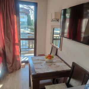 a room with a table with a bowl of fruit on it at Relax in Banyas Hidden Gem - Igzila appartment in Banya