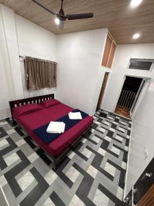 a bedroom with a red bed in a room at Nature Stay in Gokarna
