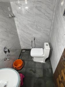 a bathroom with a toilet and a sink at Nature Stay in Gokarna
