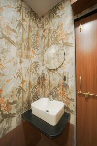 a bathroom with a sink and a wall at Bagicha villa and cottage in Mahabaleshwar +28 photos