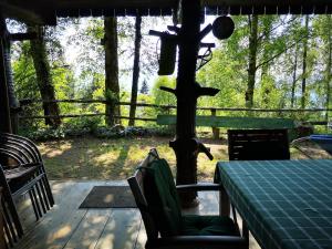 a porch with a table and chairs and a fence at The house at the larssen in Šmartno pri Slovenj Gradcu