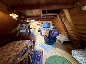 an attic room with a tv and a table at The house at the larssen in Šmartno pri Slovenj Gradcu