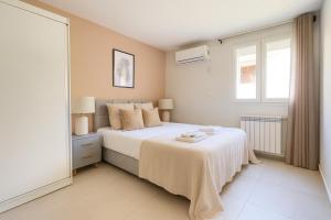 Deli IbrahimにあるMagnifique Appartement a Dely Brahimのベッドと窓のある白い寝室