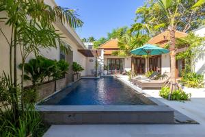 a swimming pool in the backyard of a villa at Villa Stella - Tranquillity by the beach in Sanur